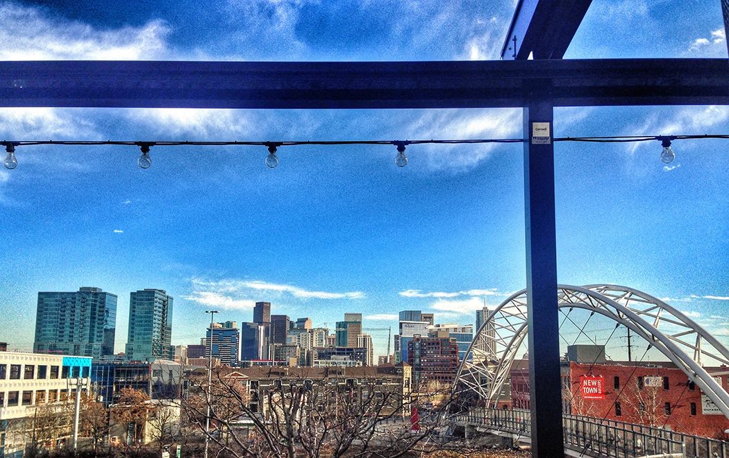 A cityscape with a bridge in the background.
